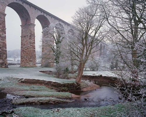 Crimple Valley Viaduct: A Marvel of Engineering and Beauty: Crimple Valley Viaduct on a frosty winter morning   a house covered in snow