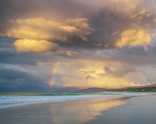 Seascapes of the Outer Hebrides:  a beach with a rainbow in the sky