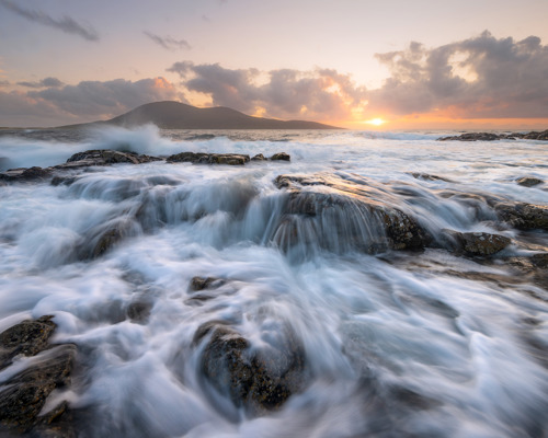 Seascapes of the Outer Hebrides:  a body of water with rocks and waves crashing on it