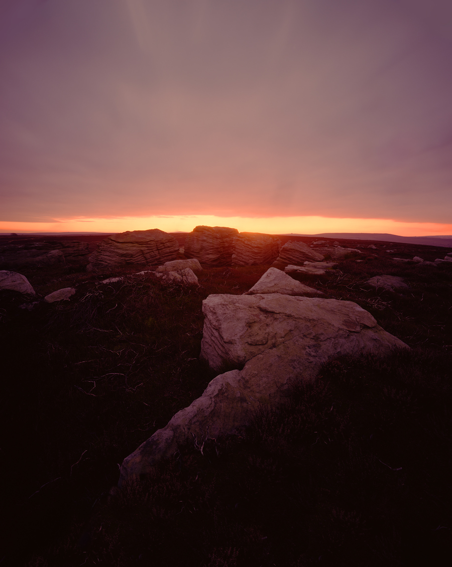 a rocky landscape with a sunset