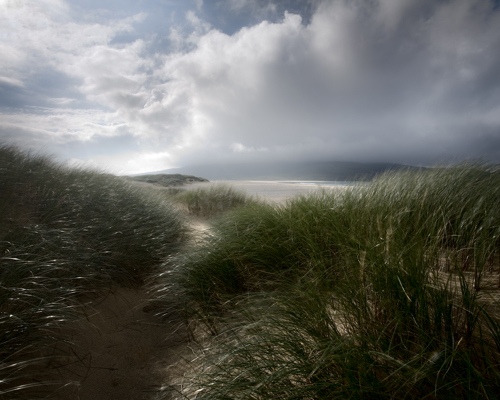 Seascapes of the Outer Hebrides:  a grassy area with a body of water in the background