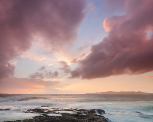 Seascapes of the Outer Hebrides:  a rocky beach with a pink and blue sky