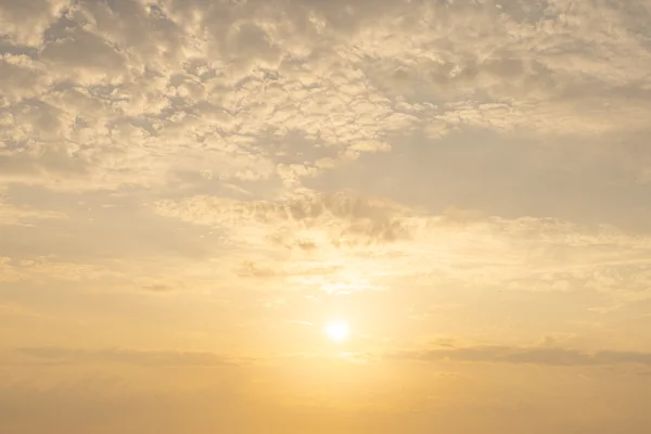 Golden sunrise sky with soft dappled cloud and a low bright sun, Swinsty, August