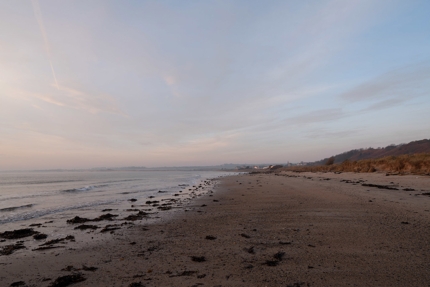  a person standing on top of a sandy beach