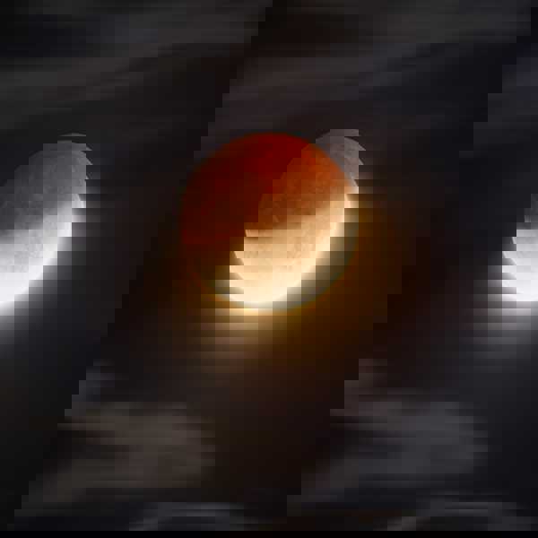 an orange ball in a dark room