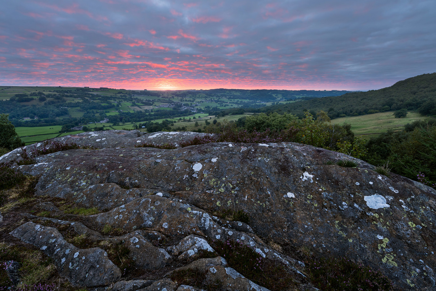  a rocky landscape with a sunset