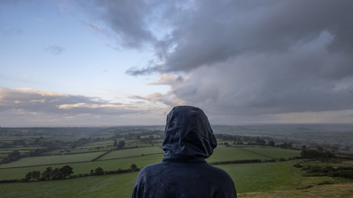  a man standing on top of a mountain