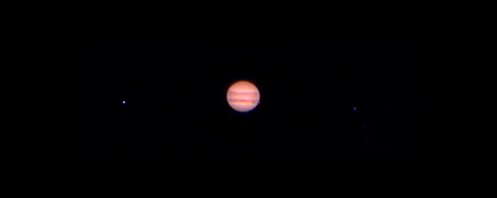 Jupiter with the shadow its moon Io through a 80mm refractor