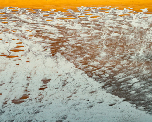 Reflections:  a frozen lake with ice